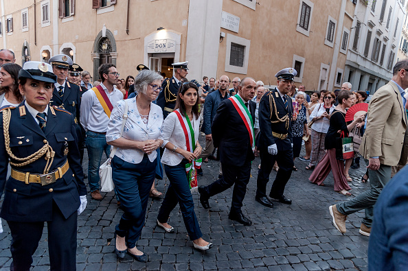 ROME, ITALY - JULY 22: The Mayor of Rome Virginia Ragii during the Solemn celebrations and procession in honor of Madonna del Carmine, Our Lady of Roman Citizens, called 'de 'Noantri', took place to Trastevere on July 22, 2017 in Rome, Italy. The bearers of the statue weighing 1,6 tons, are the Venerable Confraternity of the Blessed Sacrament and Maria del Carmine in Trastevere. The feast was officially instituted in 1927, but the origins date back to the 16th century. In 1535, after a violent thunderstorm, a statue of Mary carved out of cedar wood washed up on the shores of the Tiber. She was brought up the river and given to the then Carmelite church of St. Chrysogonus. (Photo by Stefano Montesi - Corbis/Corbis via Getty Images)